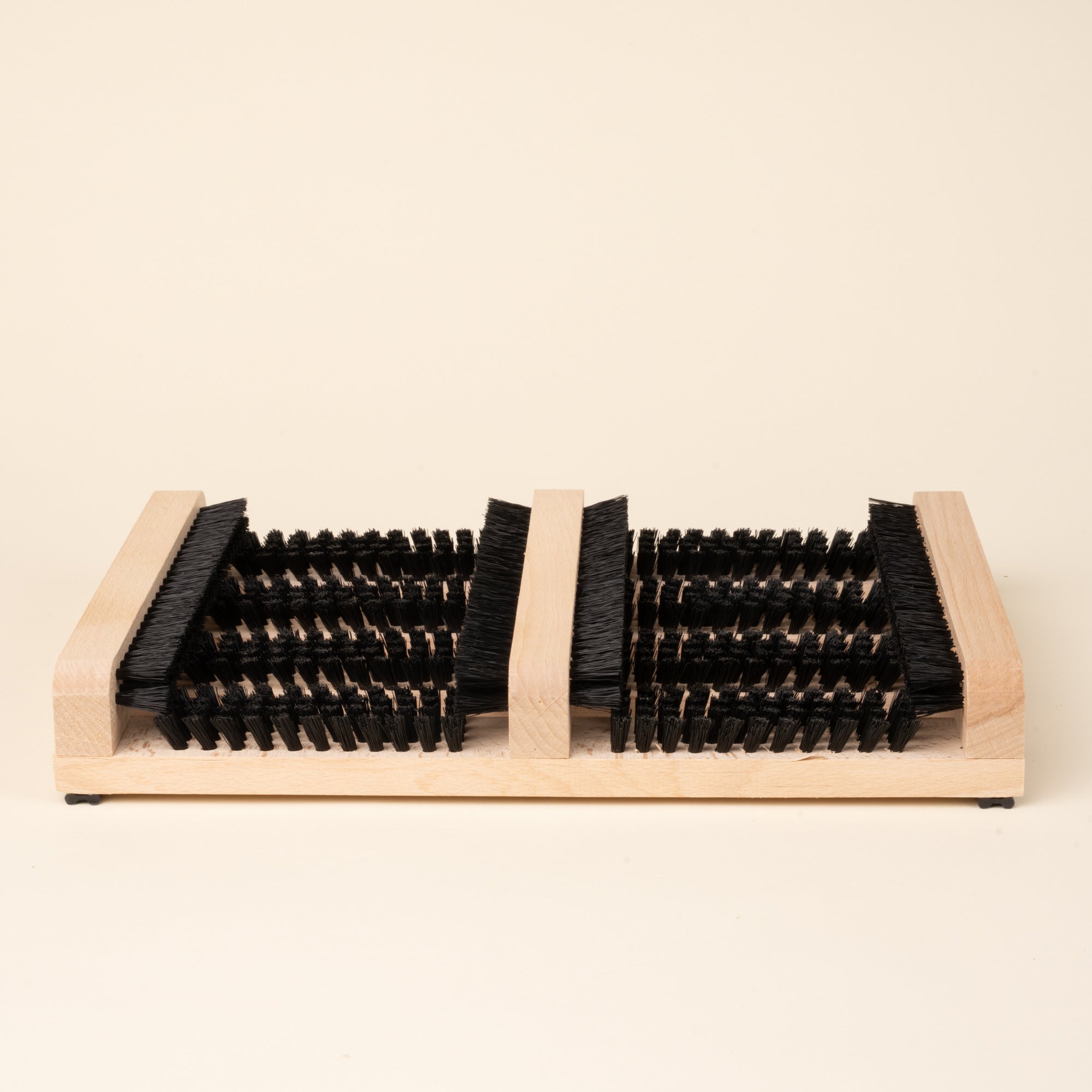 Wooden boot and shoe cleaning brush with multiple bristle sections.